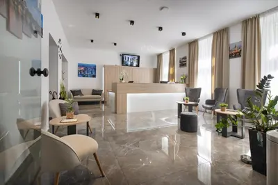 a lobby with chairs and tables and a reception desk at Prague Season Hotel in Prague