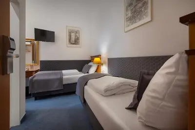 a hotel room with two beds and a television at Prague Season Hotel in Prague
