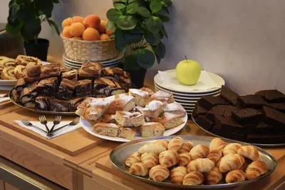 a table with different types of bread and pastries at Prague Season Hotel in Prague