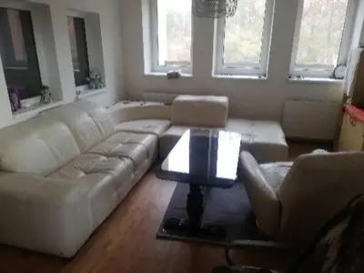 a living room with a white couch and a table at Slapská přehrada Radíč in Sedlčany