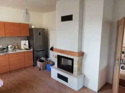 a kitchen with a fireplace in the corner of a room at Slapská přehrada Radíč in Sedlčany