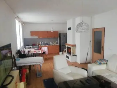 a living room with white furniture and a kitchen at Slapská přehrada Radíč in Sedlčany