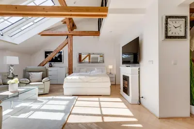 a bedroom with a bed and a living room at Wenceslass Square Royal Residence Apartments in Prague