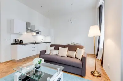 a living room with a couch and a table at Wenceslass Square Royal Residence Apartments in Prague