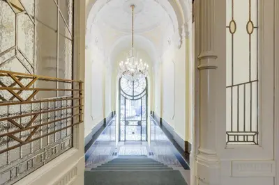a hallway in a building with a chandelier at Wenceslass Square Royal Residence Apartments in Prague