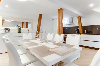 a white dining room with a white table and white chairs at Wenceslass Square Royal Residence Apartments in Prague