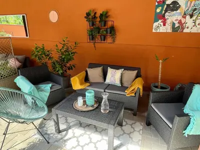 a patio with couches and a table and chairs at Penzion Villa Amélie in Mladá Boleslav