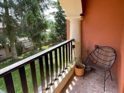 a balcony with a chair and a view of a yard at Penzion Villa Amélie in Mladá Boleslav