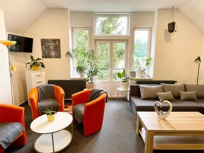 a living room with couches and chairs at Penzion Villa Amélie in Mladá Boleslav