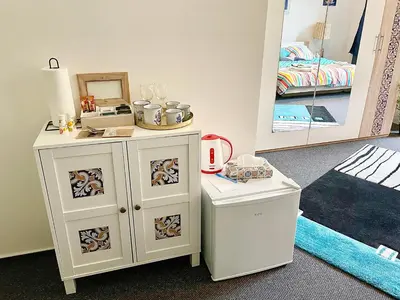 a room with a vanity with a mirror and a bed at Penzion Villa Amélie in Mladá Boleslav