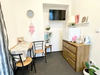 a dining room with a table and chairs and a dresser at Penzion Villa Amélie in Mladá Boleslav