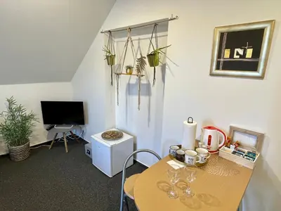 a living room with a table and a television at Penzion Villa Amélie in Mladá Boleslav