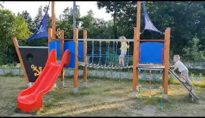 a group of children playing on a playground at Hotel Restovna in Jíloviště
