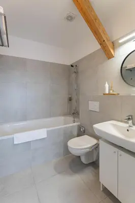 a bathroom with a tub and a toilet and a sink at Hotel Restovna in Jíloviště