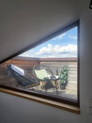a window with two chairs and a table on a balcony at Hotel Restovna in Jíloviště