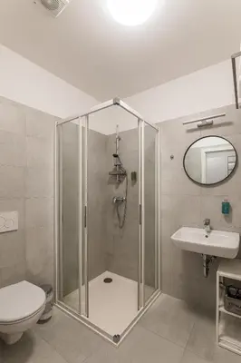 a bathroom with a shower and a toilet and a sink at Hotel Restovna in Jíloviště