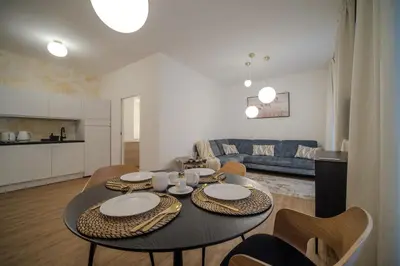 a living room with a table with chairs and a couch at Apartmán v srdci Prahy in Prague