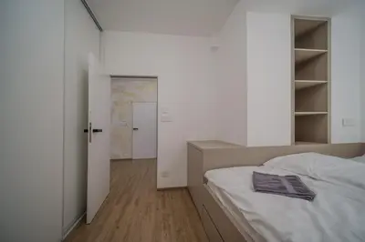 a bedroom with a bed with a book on it at Apartmán v srdci Prahy in Prague