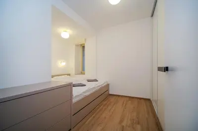 a white room with a bed and a window at Apartmán v srdci Prahy in Prague