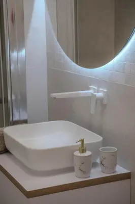 a white sink in a bathroom with a mirror at Apartmán v srdci Prahy in Prague