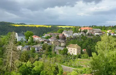 a town on a hill with trees and houses at Apartmán Kampelička in Rataje nad Sázavou