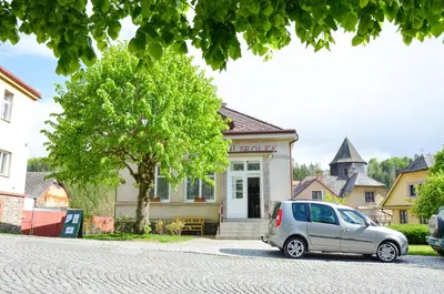 a small silver car parked in front of a house at Apartmán Kampelička in Rataje nad Sázavou