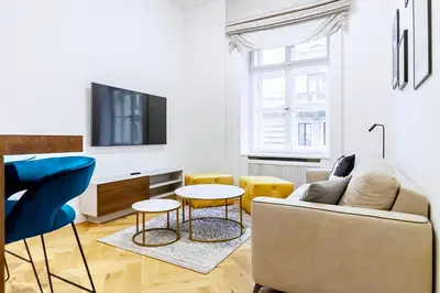 a living room with a couch and a tv at Luxury apartments in the city centre in Prague