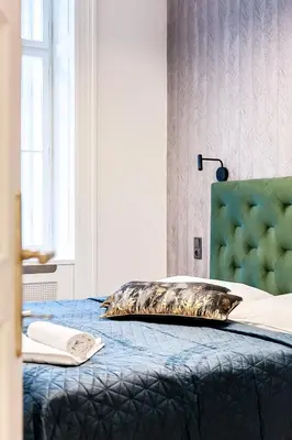 a bed with a pillow on top of it at Luxury apartments in the city centre in Prague