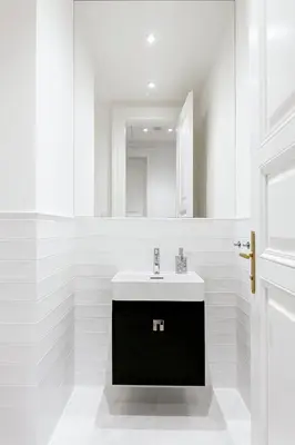 a white bathroom with a sink and a mirror at Luxury apartments in the city centre in Prague