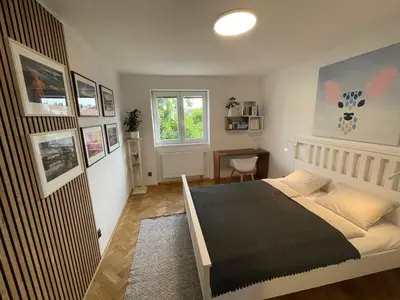 a bedroom with a bed and a window at Apartmán U Kolonády, Poděbrady in Poděbrady