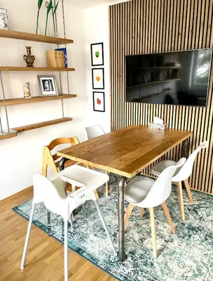 a dining room with a wooden table and chairs at Apartmán U Kolonády, Poděbrady in Poděbrady