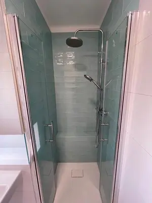 a bathroom with a shower with a glass door at Apartmán U Kolonády, Poděbrady in Poděbrady