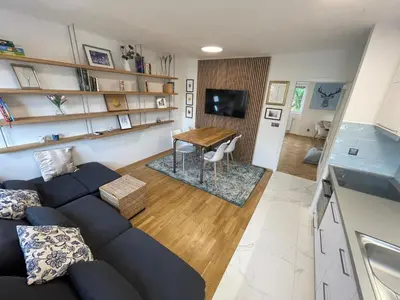 a living room with a couch and a table at Apartmán U Kolonády, Poděbrady in Poděbrady