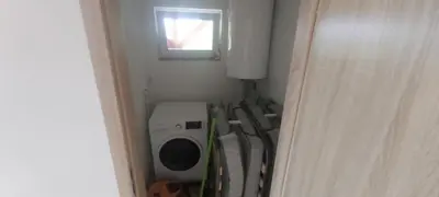 a small bathroom with a washing machine and a window at Bungalov Silvie in Litoměřice