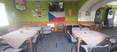 a dining room with tables and chairs and a flag at Bungalov Silvie in Litoměřice