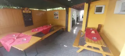 a small restaurant with two tables and red napkins at Bungalov Silvie in Litoměřice