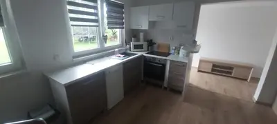 a kitchen with white cabinets and a counter top at Bungalov Silvie in Litoměřice