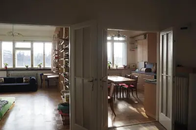 a kitchen and living room with a table and a dining room at Rodinný apartmán v centru Prahy in Prague