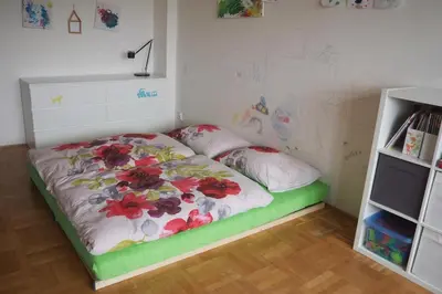 a small bedroom with a bed with flowers on it at Rodinný apartmán v centru Prahy in Prague