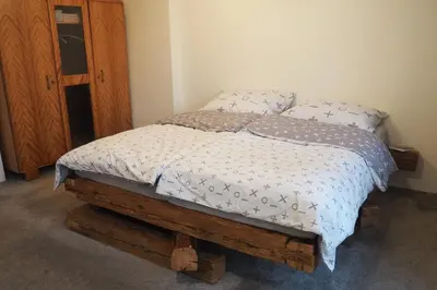 a bedroom with a bed with a wooden foot board at Rodinný apartmán v centru Prahy in Prague