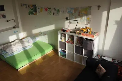 a small bedroom with a bed and a book shelf at Rodinný apartmán v centru Prahy in Prague
