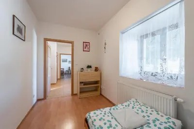 a small bedroom with a bed and a window at Apartmán v Ladově kraji in Ondřejov