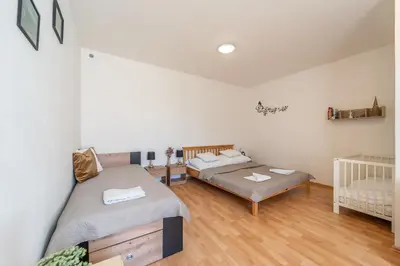 a bedroom with two beds and a crib at Apartmán v Ladově kraji in Ondřejov