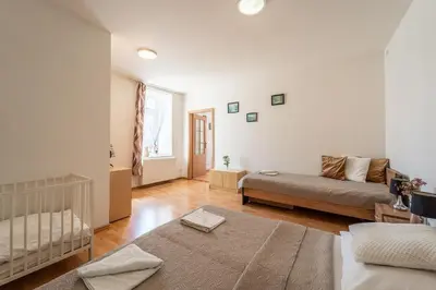 a living room with a couch and a crib at Apartmán v Ladově kraji in Ondřejov