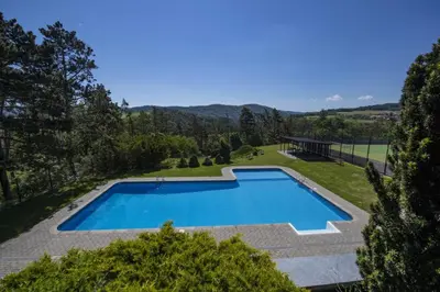 an overhead view of a swimming pool in a yard at Hotel Berounka in Hřebečníky