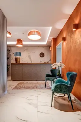 a lobby with two chairs and a table at Hotel Central Park in Poděbrady