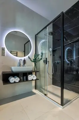 a bathroom with a shower and a sink and a mirror at Hotel Central Park in Poděbrady