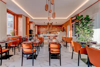 a restaurant with tables and chairs and a bar at Hotel Central Park in Poděbrady