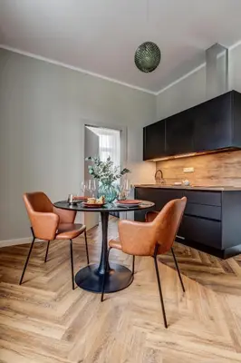 a kitchen with a table and chairs in a room at Hotel Central Park in Poděbrady