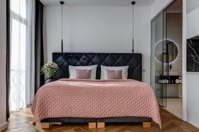 a bedroom with a large bed with a black headboard at Hotel Central Park in Poděbrady